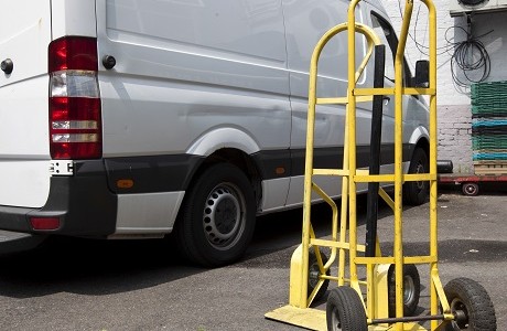sack trolley in front of white van representing Goods in transit insurance